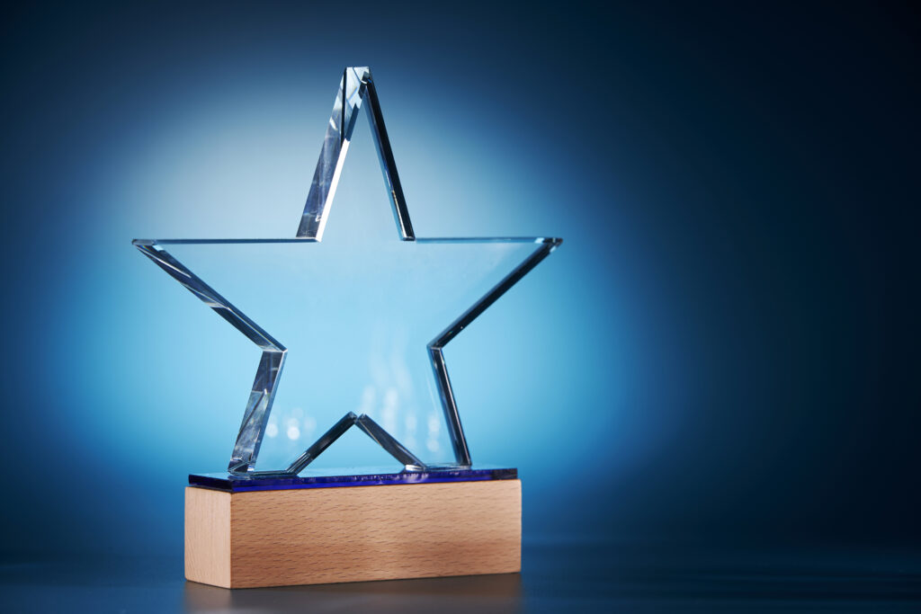 decorative image of an award shaped like a star on a blue background